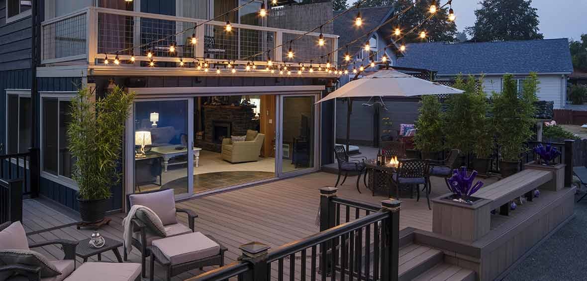 Composite deck at dusk with string lights and lounge seating