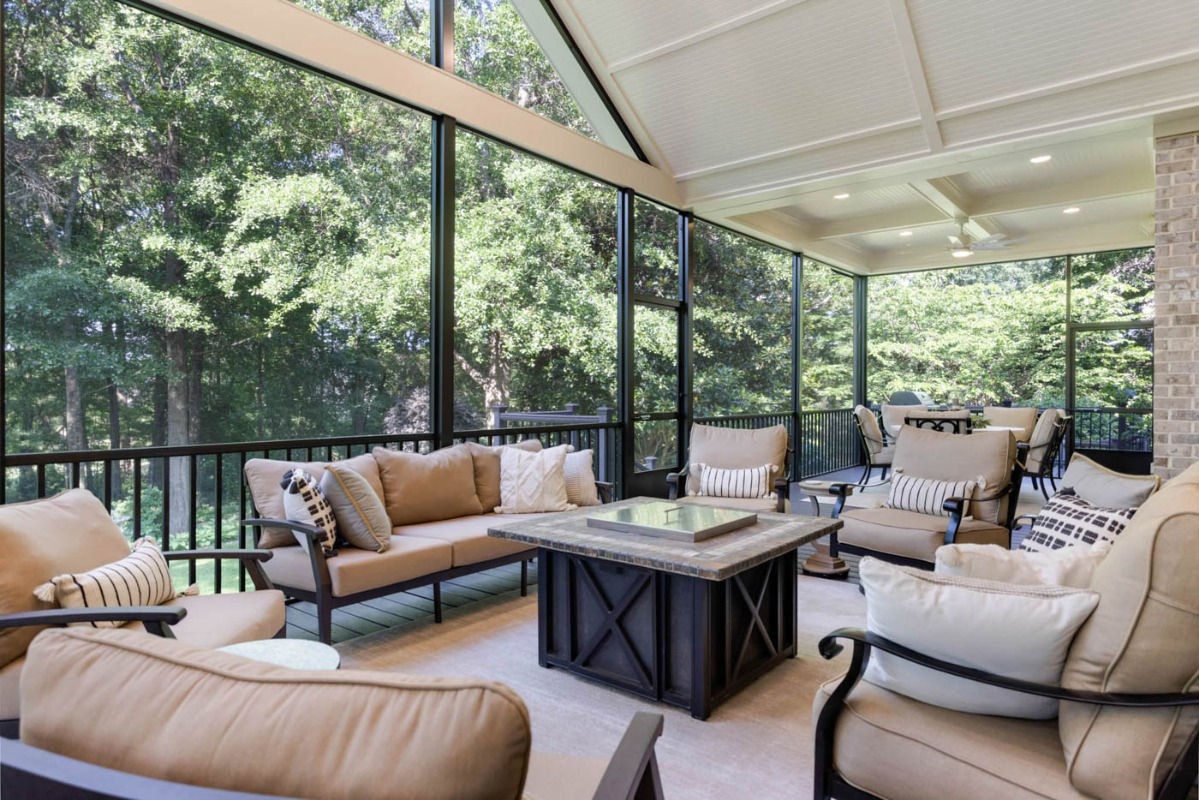 Grand screened porch with vaulted ceiling and fire table